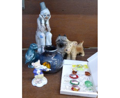 A Poole vase and otter, two Sylvac dogs, one a/f, a Spanish figure of a clown, a figure of a cat and glass novelty sweets