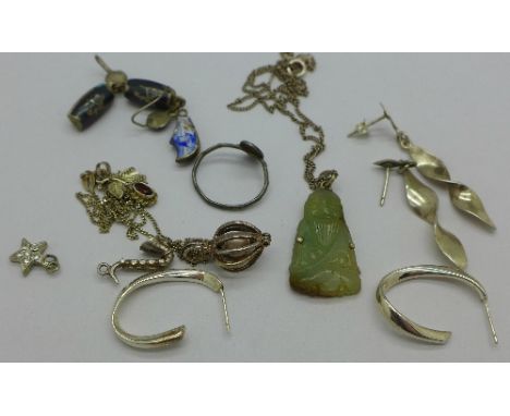 A jade pendant on a silver chain and silver earrings, etc.