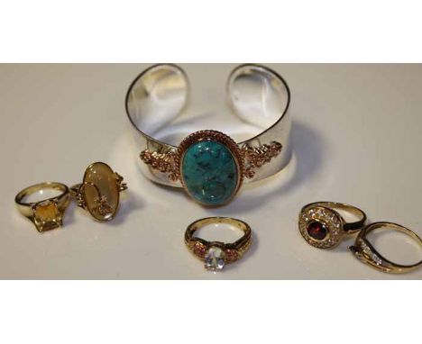 GROUP OF FIVE NINE CARAT GOLD GEM SET RINGS
including a sapphire ring, a citrine ring, and a mother of pearl ring, along with