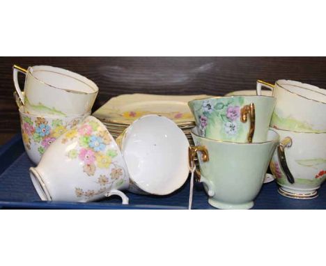 HAND-PAINTED PART TEA SET
of purple and blue floral decoration, comprising five cups, five suacers and six side plates, each 