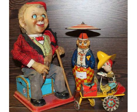 VINTAGE TIN TOY
and two others
