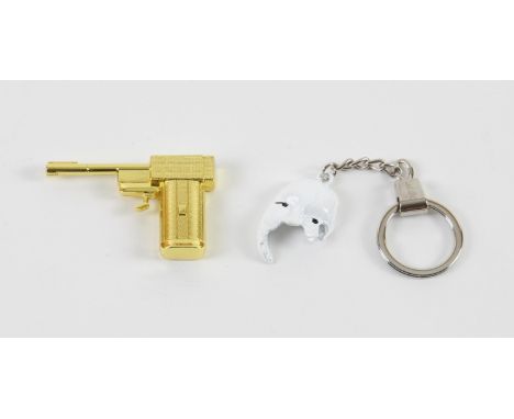 James Bond - Official 007 Safin Mask keyring and a Golden Gun metal fridge magnet (2). 