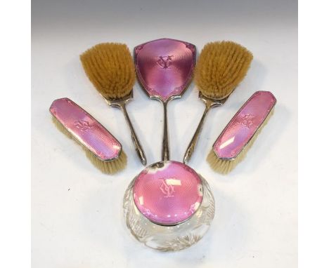 George V silver and pink enamel five piece brush set with matching cut glass powder bowl, each piece with the initials G.Y., 