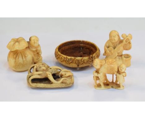 Late 19th/early 20th Century Japanese carved ivory netsuke formed as a man playing a stringed instrument, together with four 