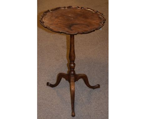 George III style mahogany circular top wine table having a pie-crust edge and standing on a slender turned baluster pillar an