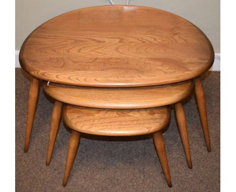 Nest of three Ercol natural elm and beech D shape coffee tables, all standing on triple tapered supports   Condition: 
