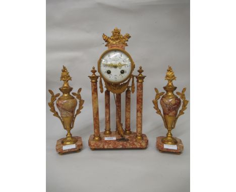 French rouge marble and ormolu mounted three piece clock garniture having circular enamel dial with floral swags and Arabic n