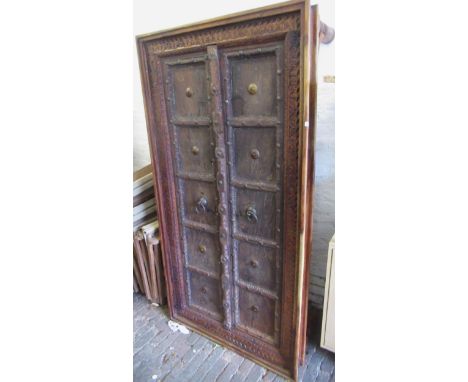 Large antique Indian hardwood and metal mounted panelled door adapted for use as a coffee table, in a modern hardwood frame w