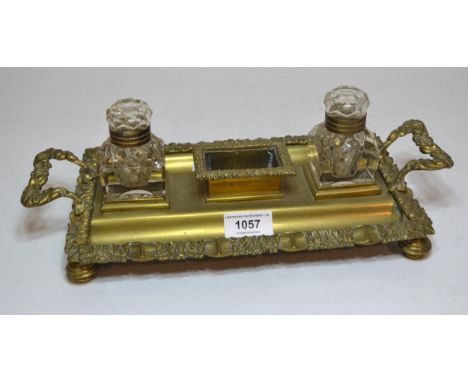 19th Century brass two bottle inkstand, 33cm wide, together with a brass oil lamp and five various fire tools 
