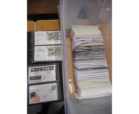 Two black albums containing a quantity of First Day covers and a large quantity of loose First Day covers 