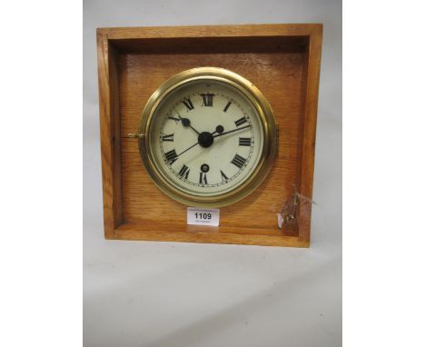Ship's circular brass bulkhead clock, the enamel dial with Roman numerals, the single train movement with centre seconds, 6in