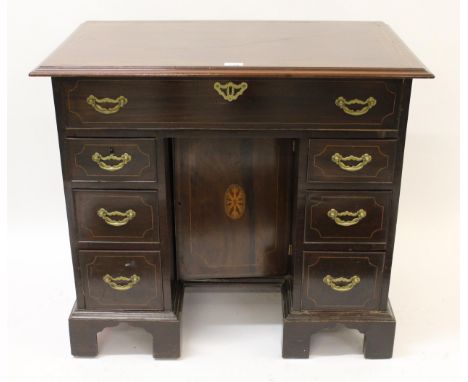 19th / early 20th Century mahogany crossbanded and line inlaid kneehole desk in George III style, the moulded top above nine 