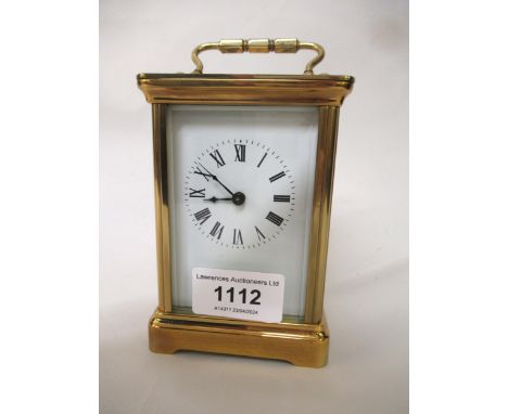 Modern brass cased carriage clock having enamel dial with Roman numerals, including key, 12cm high 