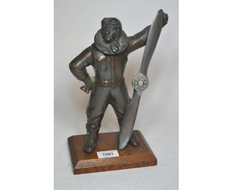 Mid 20th Century patinated spelter table lighter in the form of an aviator on an oak plinth base, 17cm high 