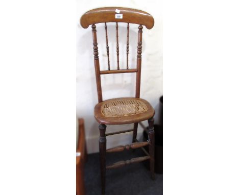 19th Century beechwood correction chair with spindle back and cane seat, together with an oak four shelf open bookcase 