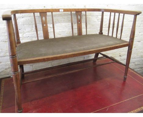 Edwardian beechwood drawing room sofa with a pierced splat and spindle back above a padded seat on turned supports 