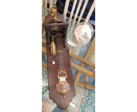 Late 20th Century brass anniversary style clock under glass dome and fitted to a wall bracket, striking on a bell, 92cm high 