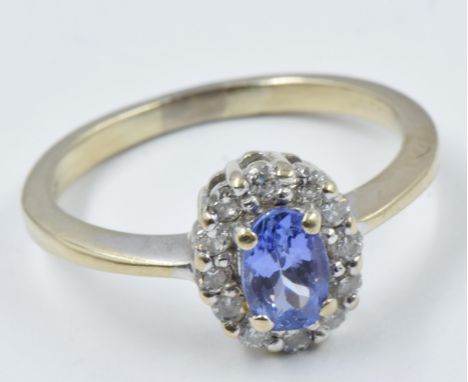 Small 18ct gold tanzanite and diamond oval cluster ringSize between K and L 