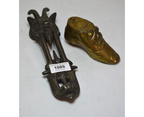 Patinated iron door knocker in the form of a rams head, 27cm high, together with a brass inkwell in the form of a shoe 