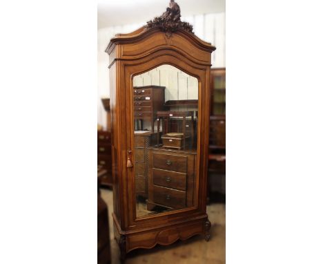 19th Century French walnut double bedstead, together with a matching wardrobe with a floral carved surmount above a bevelled 