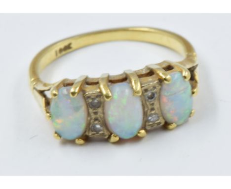 18ct Gold ring set three opals and four small diamond chips3.2g in weight 
