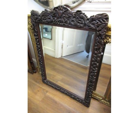 Large Chinese carved hardwood wall mirror, decorated with dragons, having bevelled plate, 110 x 80cm 