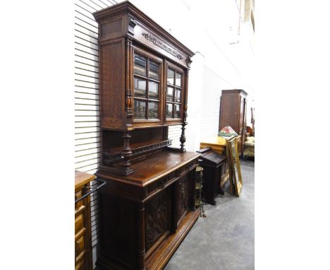 19th century Continental carved oak dresser, with lunette carved frieze, the pair of bevelled plain glass doors enclosing adj