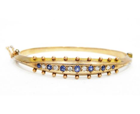 9ct gold, sapphire and diamond bangle set with seven graduated sapphires and six old cut diamonds (PLEASE NOTE NEW ESTIMATE) 