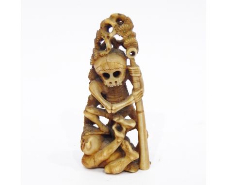 Late 19th/early 20th century Japanese marine ivory model of a skeleton trampling on an oni, 8cm high 