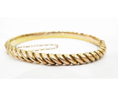 Gold-coloured metal hinged bangle, rope-pattern 