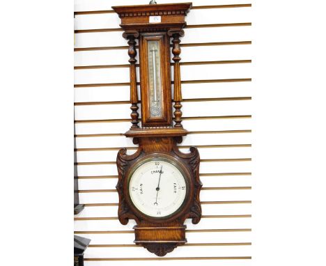 19th century oak-cased aneroid barometer with dentil cornice and temperature gauge flanked by columns, with pressure dial bel