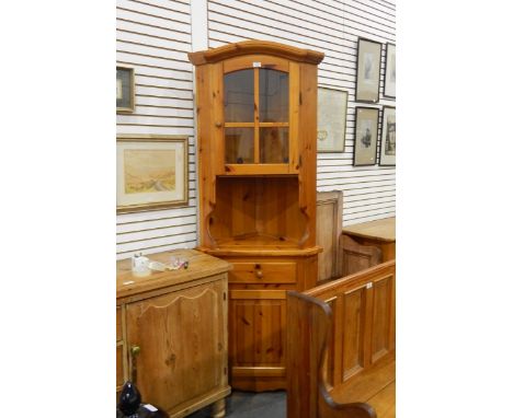 Modern pine corner cupboard, the glazed upper section enclosing shelf with open cupboard below, frieze drawer and further cup