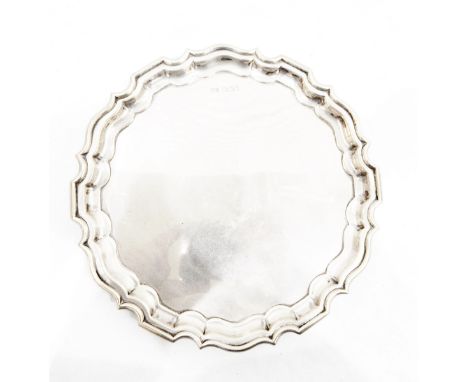 Silver salver by Walker & Hall, Sheffield 1919, of shaped circular form, on three scroll feet, 21cm diameter, 11oz (PLEASE NO