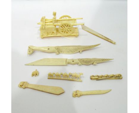 Late 19th/early 20th century Indian carved ivory model of a cart pulled by buffalo, two bone paper knives modelled as alligat