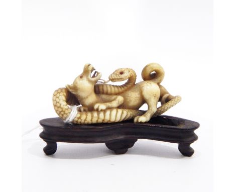 Late 19th/early 20th century Japanese carved ivory model of a dog fighting a serpent, with signature to underside, 7cm long w