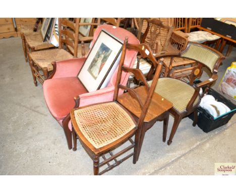A ladder back cane seated chair and an oak stool