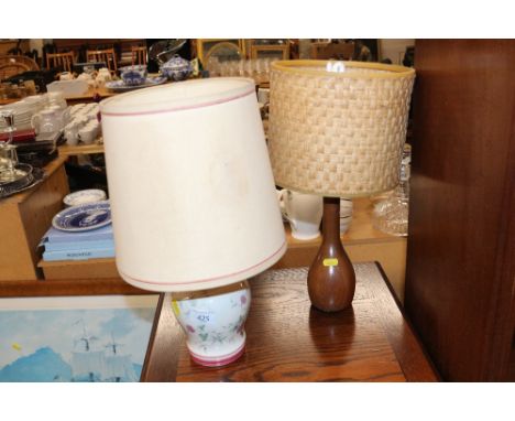 A decorative porcelain table lamp and a wooden similar 