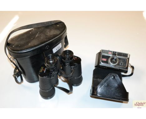 A pair of cased binoculars and a camera