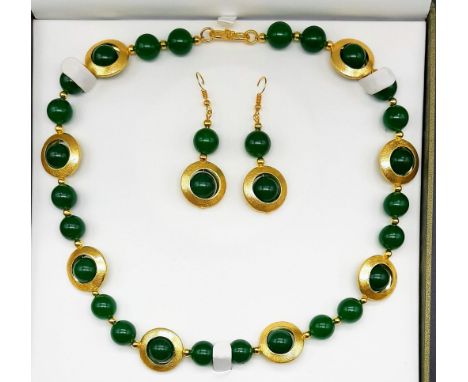 A 60?s style green jade with gilded accents necklace and earrings set in a presentation box. Necklace length: 51 cm, earrings