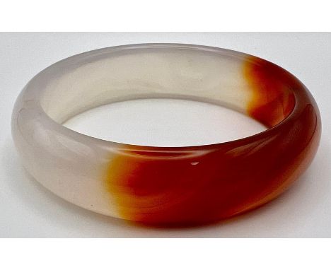 A White and Red Jade Bangle. 6cm inner diameter, 