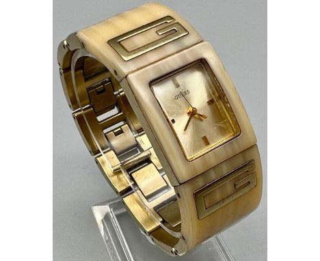 A Guess Ladies Gilt and Ceramic Quartz Dress Watch. In working order. 