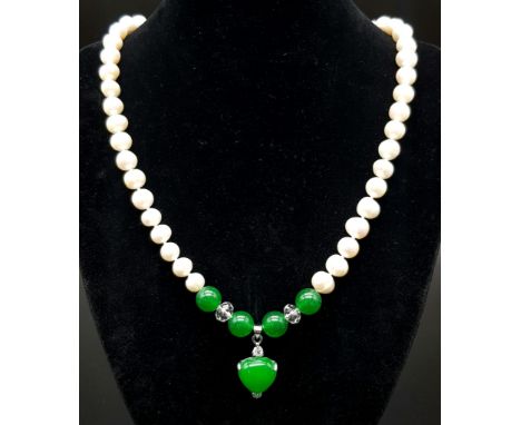 A Freshwater Pearl and Green Jade Necklace. 7mm pearls. 8mm jade and a 15mm jade heart. 48cm. 