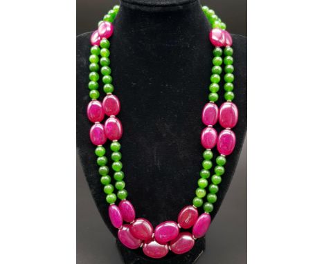 A 650ct Jade and Ruby Bead Necklace. Circular jade beads with oval rubies. 8 and 20mm beads. 44-48cm. 