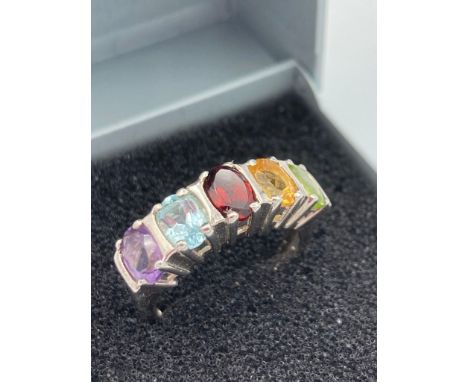 SILVER RING with multi stones set to top in the colours of Amethyst, Aqua, Garnet ,Topaz and Peridot.Size L . 