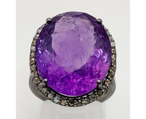 A 19ct Amethyst Gemstone ring with .45ct diamonds in pave setting, 925 silver black antique finish. 44cm 