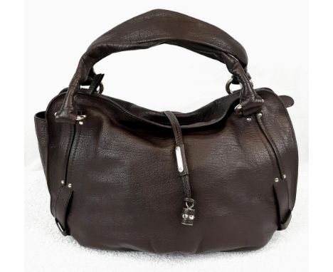 A Brown Leather Celine Handbag. Classic double handle with gilded hoops. Celine tassel decoration. Monogramed cloth interior.