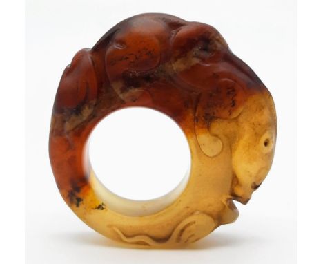 A Chinese, Archaic style, two tone jade ring, hand carved with a mythical beast and a frog. Dimensions: 52 x 52 x 13 mm, weig