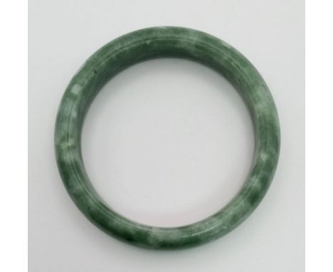 A Pale Green and White Jade Bangle. Inner diameter 6cm. 