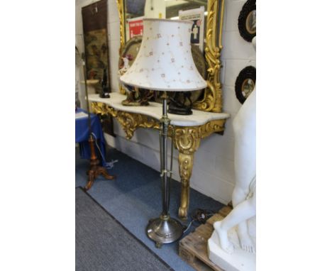 A brass and lacquered steel classical style floor standing lamp.