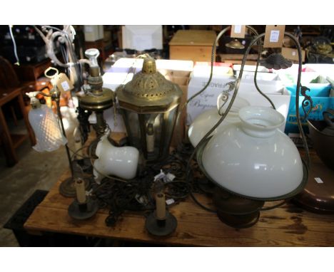A quantity of various lighting to include a wrought iron chandelier.
